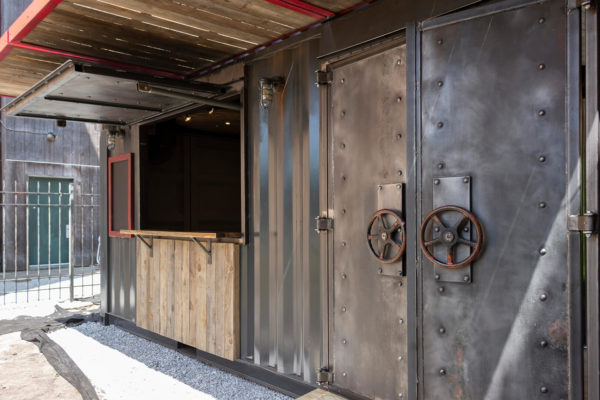 Right-angled view of the Drydock container bar, with the focus on the industrial-style doors