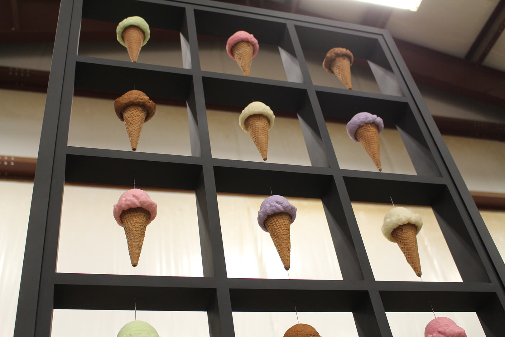 Ice cream display for Cream & Sugar in the ZENTX workshop, showing artificial ice cream cones suspended between segments of the frame