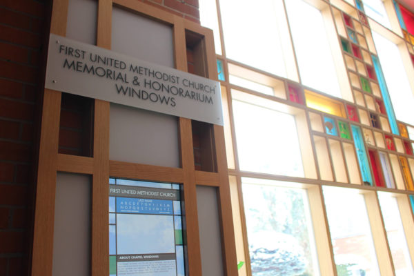 One touchscreen kiosk, with stained glass windows in the background