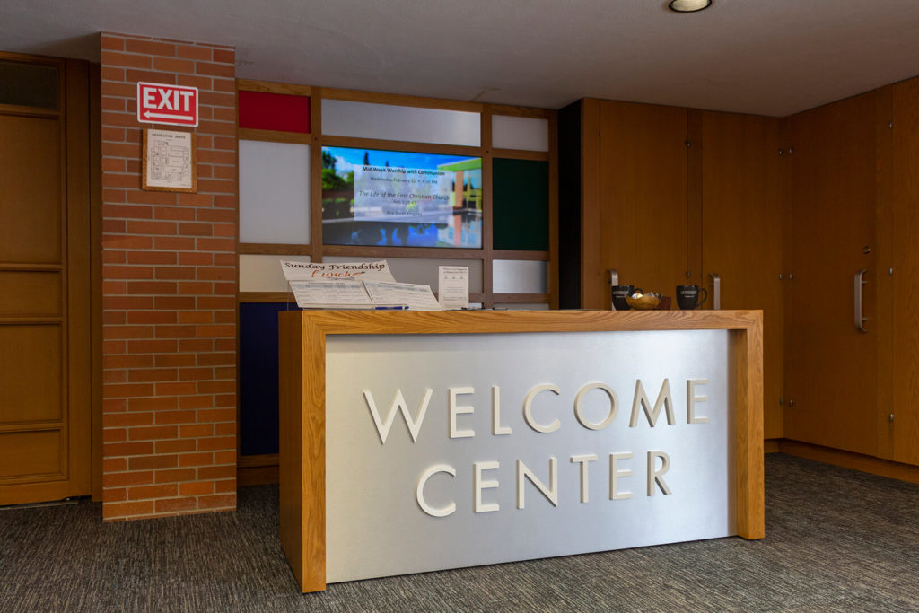 Side view of welcome center, showing table and decorative backdrop