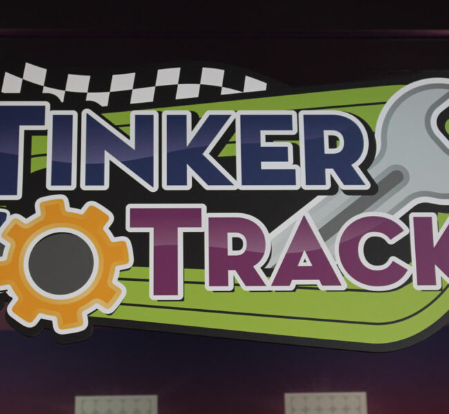 Sign reading "Tinker Track" for exhibit at Mid-Michigan Children's Museum