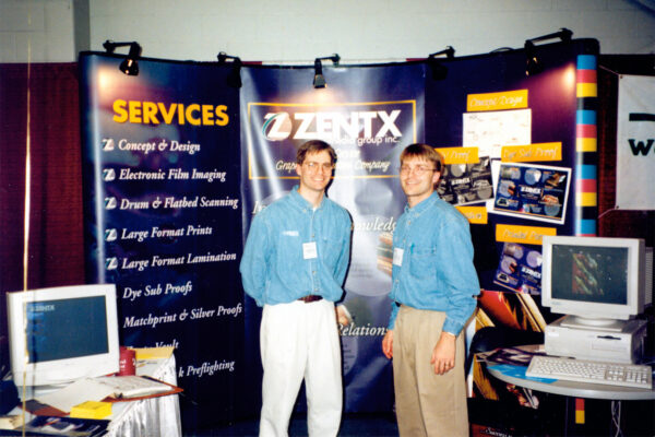 Mark and Mike Wenz standing in front of ZENTX's trade show booth