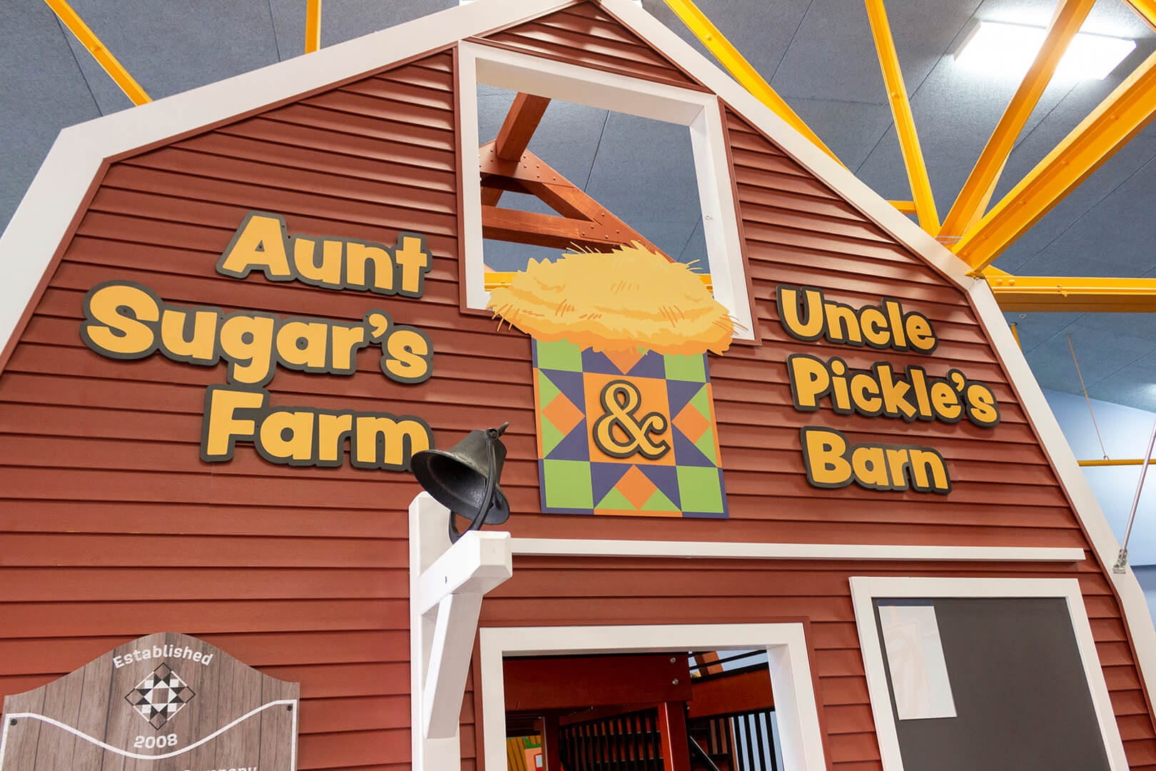 Sign outside farm exhibit. Text reads, "Aunt Sugar's Farm and Uncle Pickle's Barn."